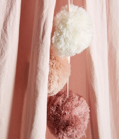 Pink reading tent with pom-poms